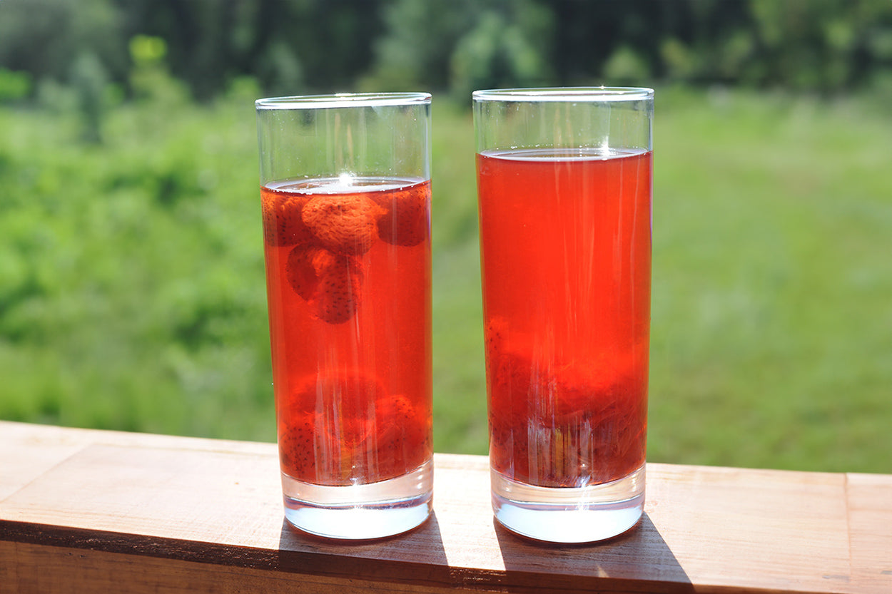 Glasses of rhubarb and strawberry compote with fresh strawberries